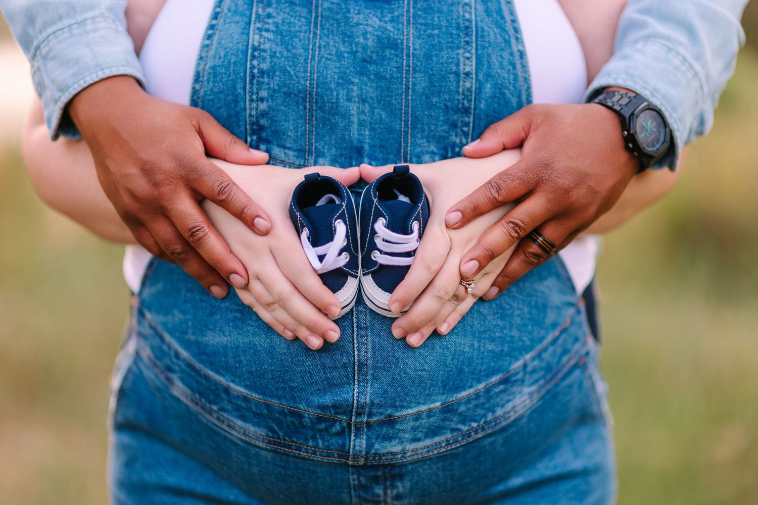 Woman wearing denim overalls shows different poses of her casual outfit during a lifestyle photography session outdoors.