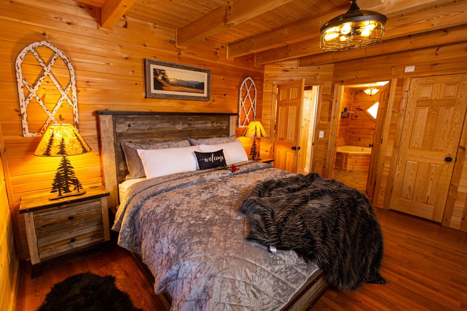 Rustic log cabin bedroom featuring wooden walls, decorative lighting, and comfortable bedding.