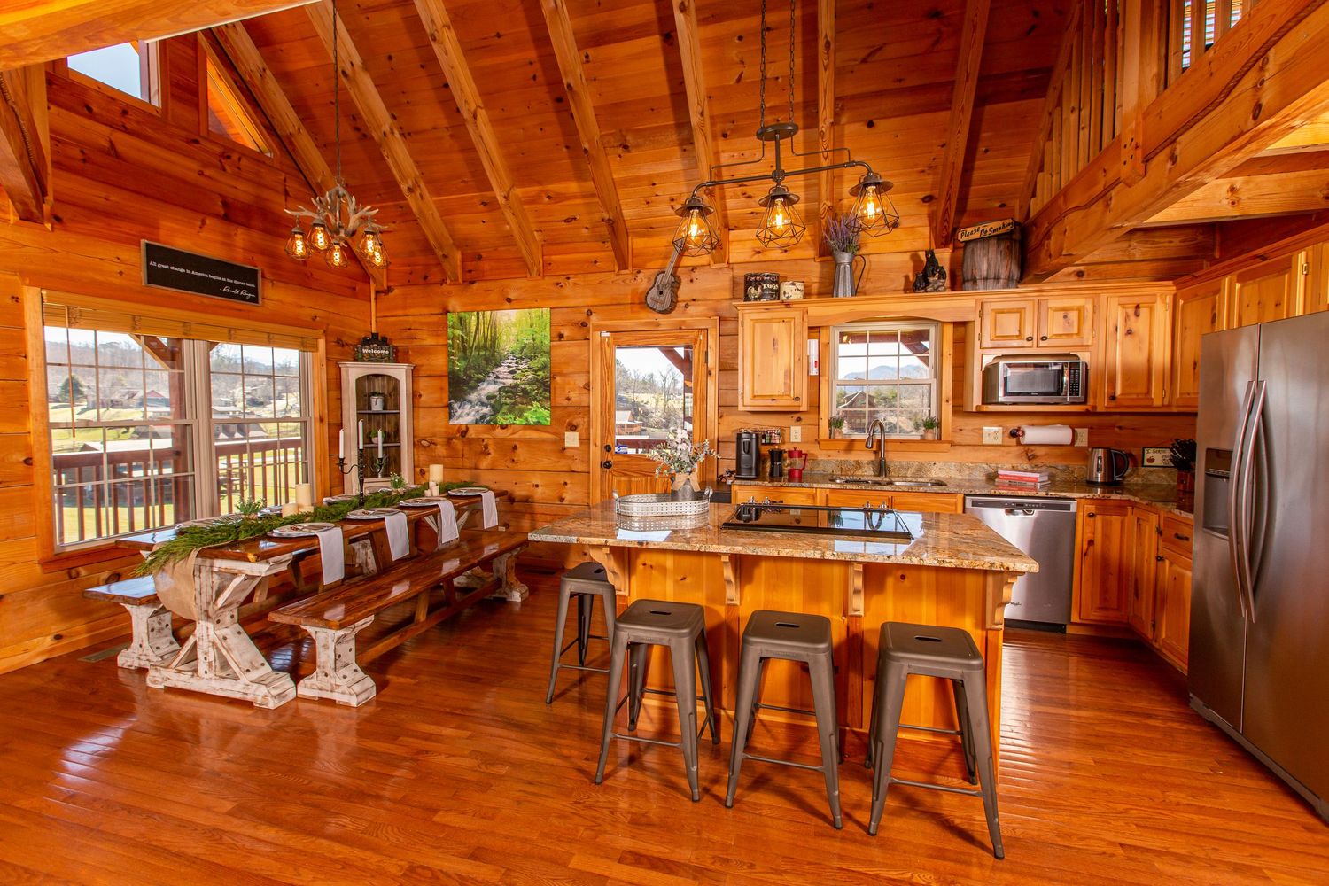 Spacious log cabin interior with vaulted ceilings, rustic wood finishes, and open floor plan design.