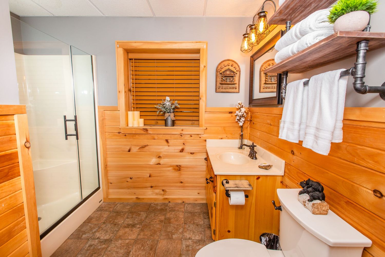 Clean white bathroom with pine accents featuring modern fixtures and fresh towels.
