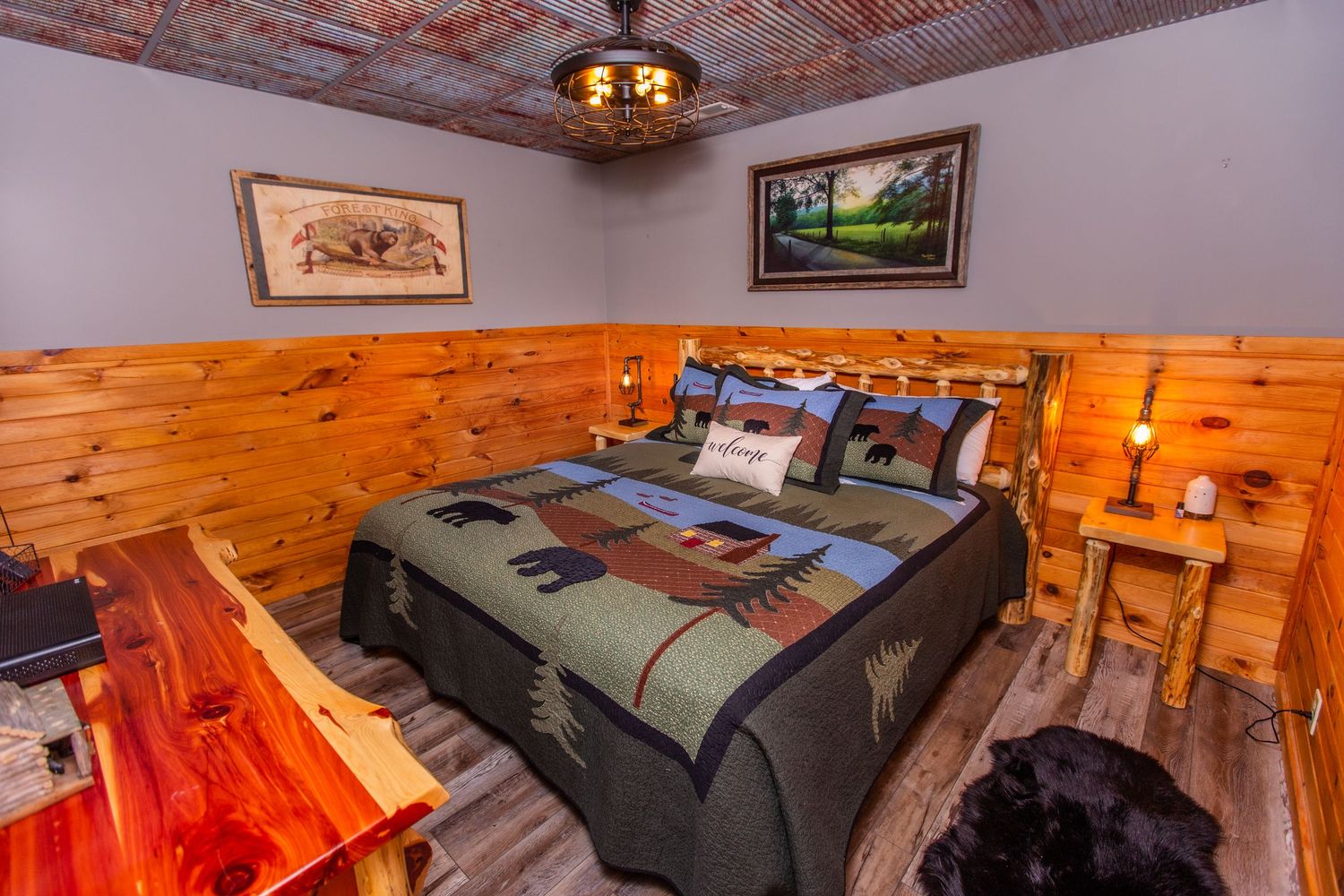 Rustic log cabin interior with multiple bedrooms featuring wooden walls, cozy lighting and comfortable furnishings.