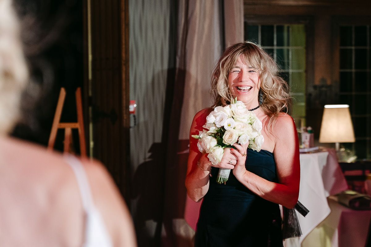 Guest catching bouquet during wedding at Manoir de Lébioles