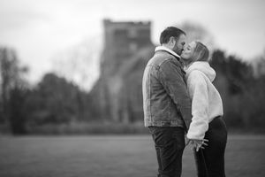 Romantic black and white photo series of a couple embracing in an outdoor setting.