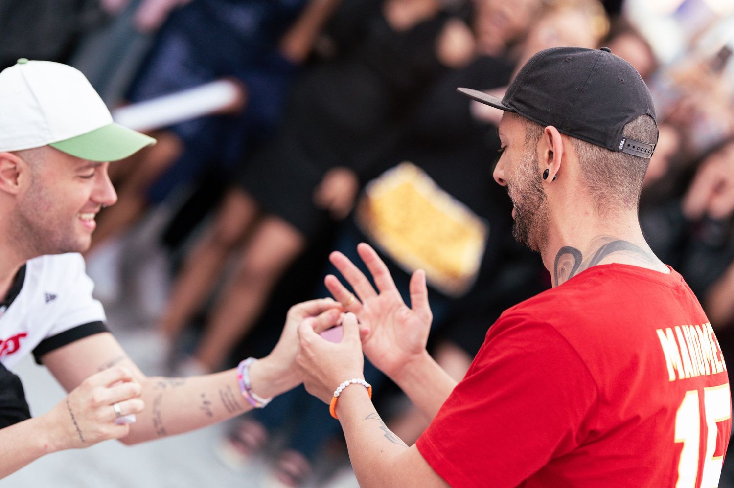 Two fans celebrate together with an enthusiastic high-five at a sporting event.