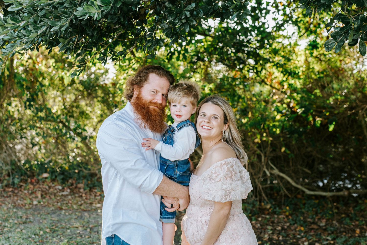 Happy family spending quality time together outdoors in a lush garden setting on a sunny day.