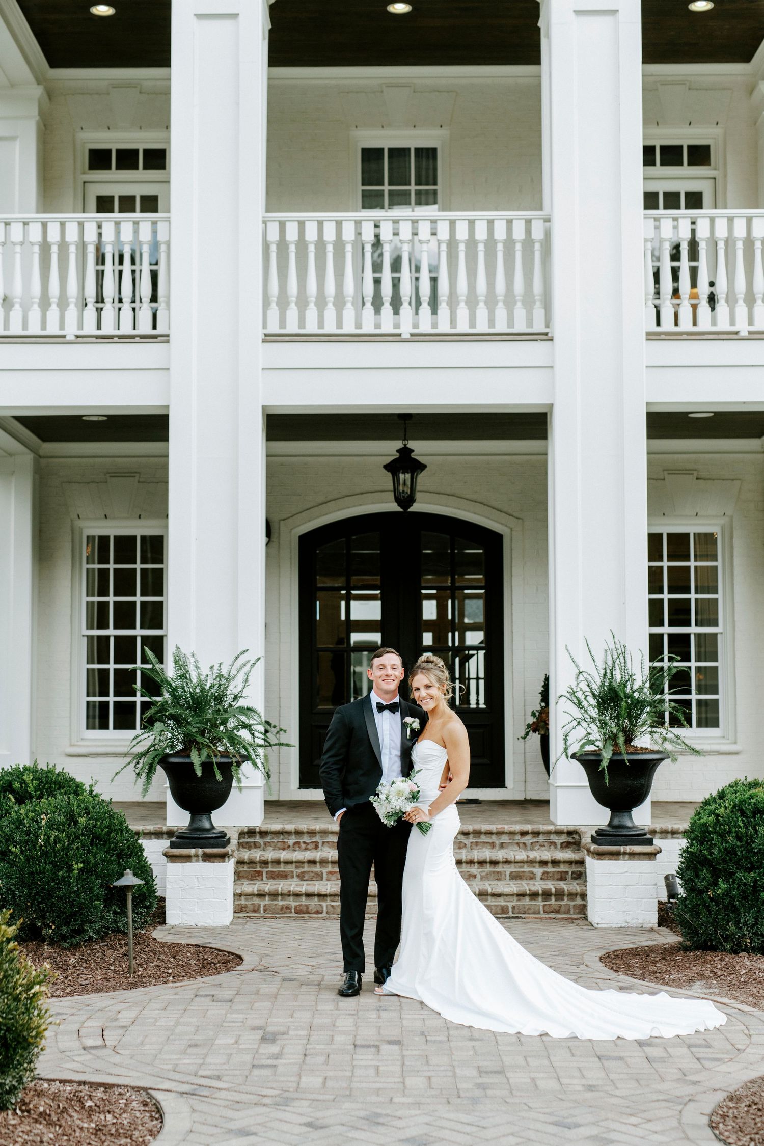 Elegant white mansion wedding venue with white columns and brick walkway displayed in five panel photo collage.