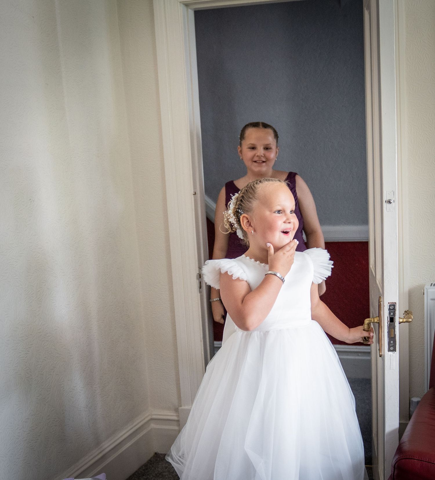 Series of photos showing a playful child in a white fluffy dress spinning and dancing in a hallway.