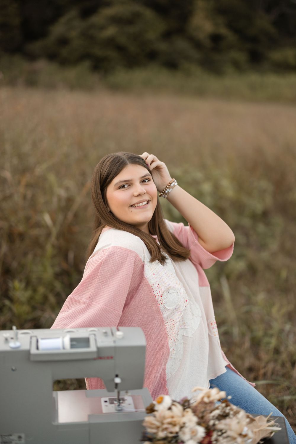 Candid shots of a person in pink sweater and white lace dress sitting at a gray sewing machine outdoors.