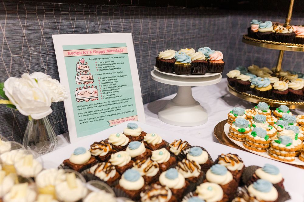 Assorted chocolate cupcakes with blue and white frosting displayed at a bakery counter.