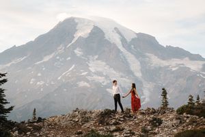Mountain landscape proposal photoshoot with dramatic snow-capped peaks in background.