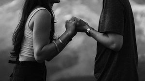 A sequence of black and white dance moves showing arm and body movements in synchronized poses against a neutral backdrop.