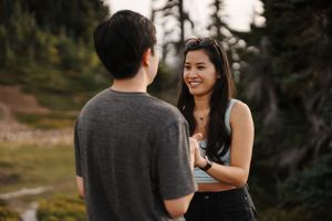 A couple shares intimate moments in nature during a sunset photo session in the mountains.