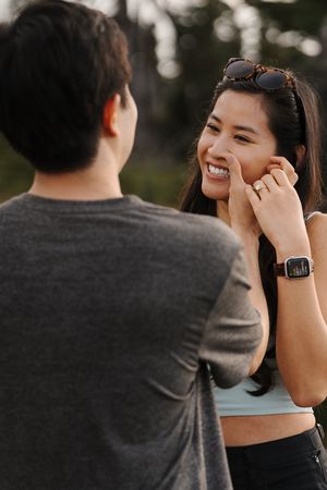 A couple shares joyful laughter together during an intimate moment at sunset.