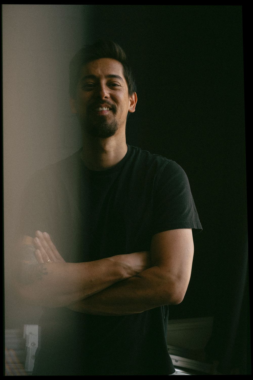 Moody portrait series showing a person in a black t-shirt against a dark background with varying poses.