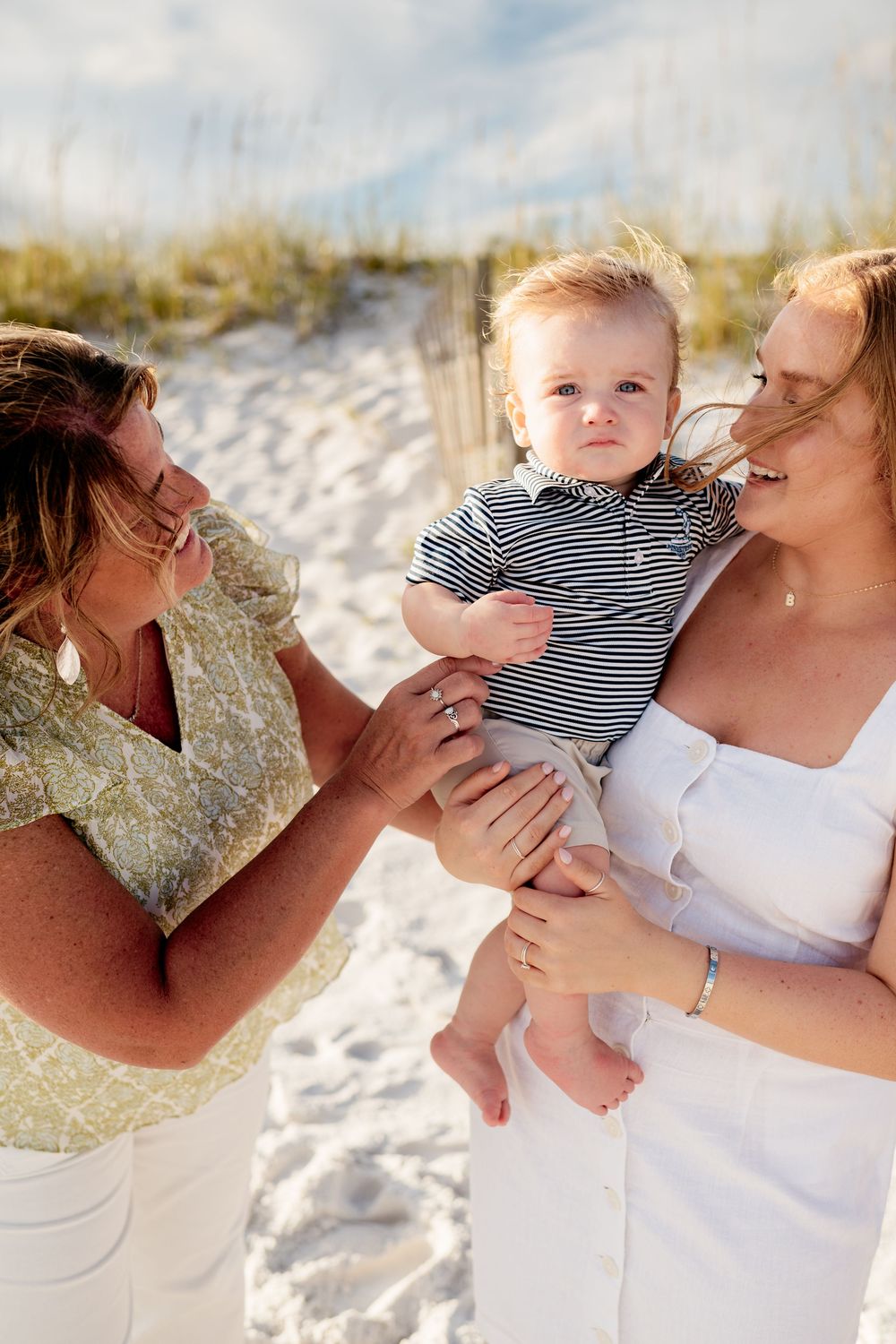 A series of tender moments between parent and child on a sunny beach with white sand.