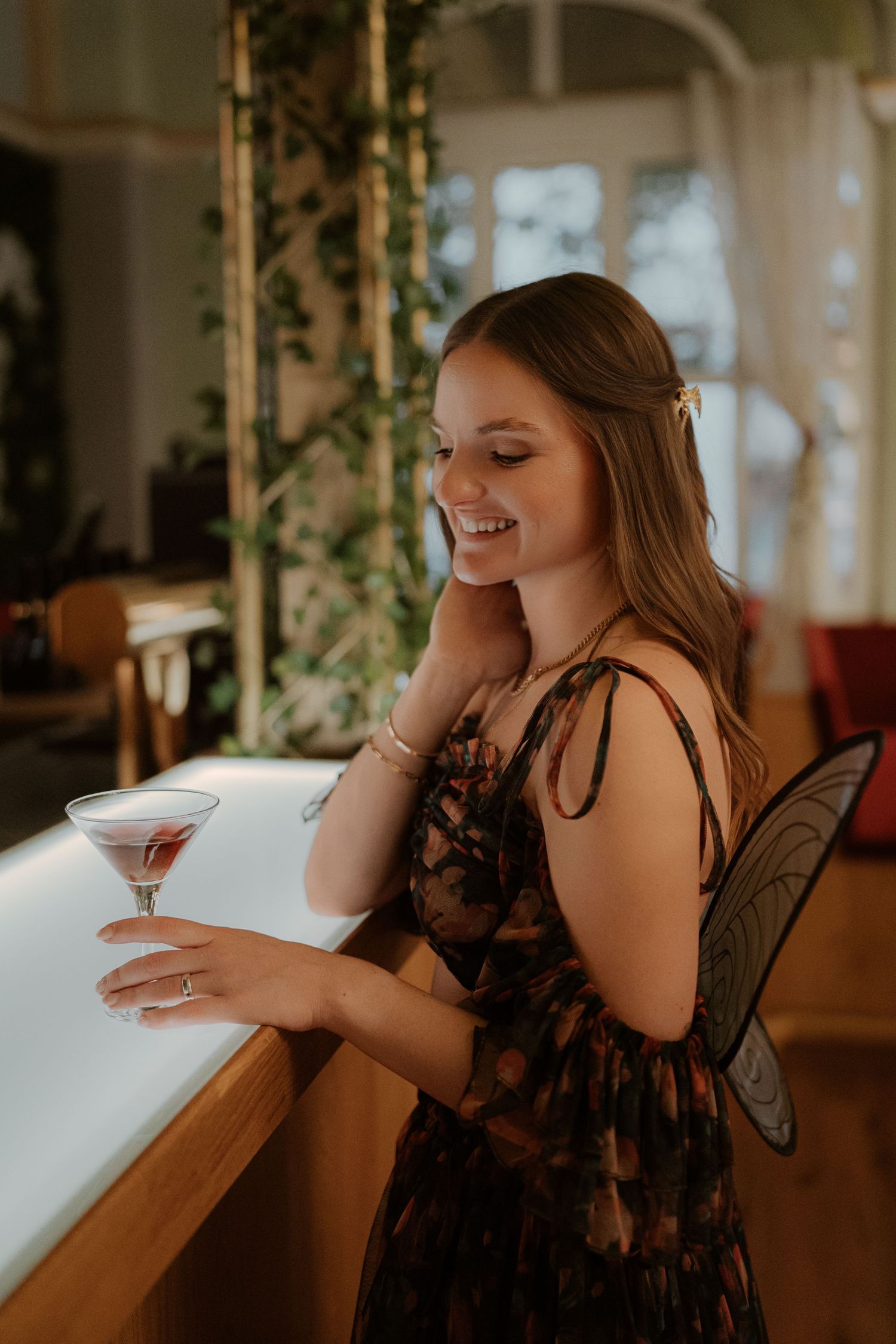 Elegant hotel interior with crystal chandeliers, ornate white moldings, and red velvet furniture in a luxurious setting.