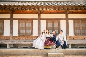 Traditional Korean palace architecture with curved tile roof and wooden beams in warm sunlight.