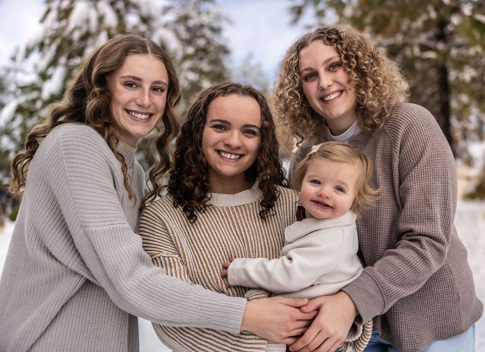 Winter family photoshoot featuring natural poses and neutral colored clothing.