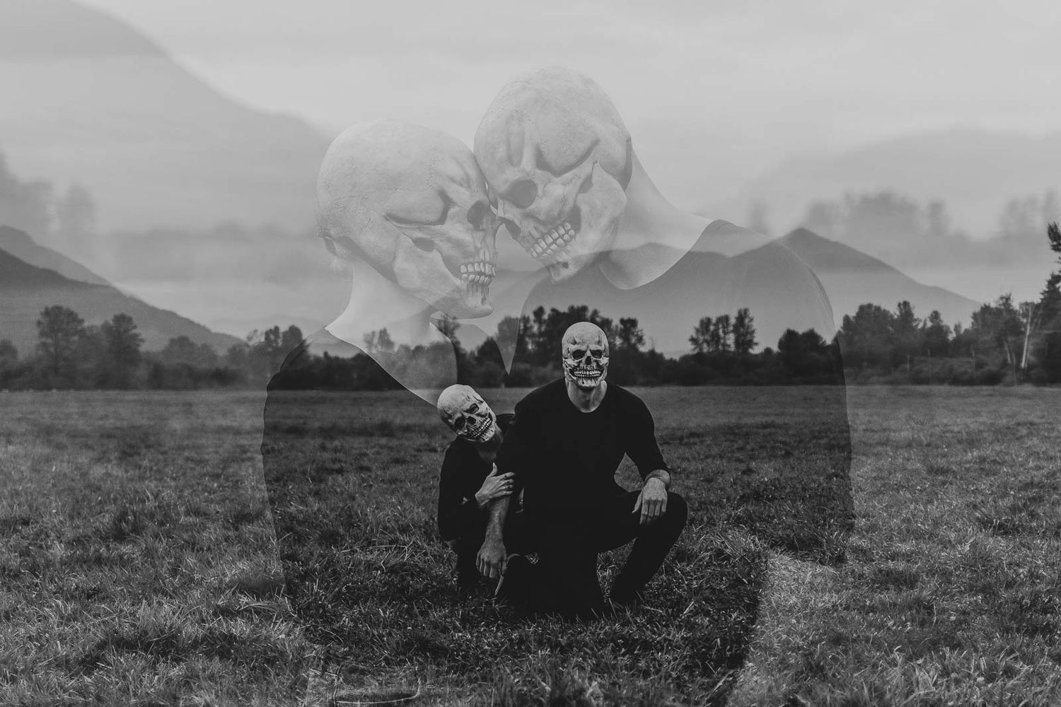 Creative black-and-white double exposure of two figures in skull masks for a moody Halloween couples photoshoot, spokane washington, cheney