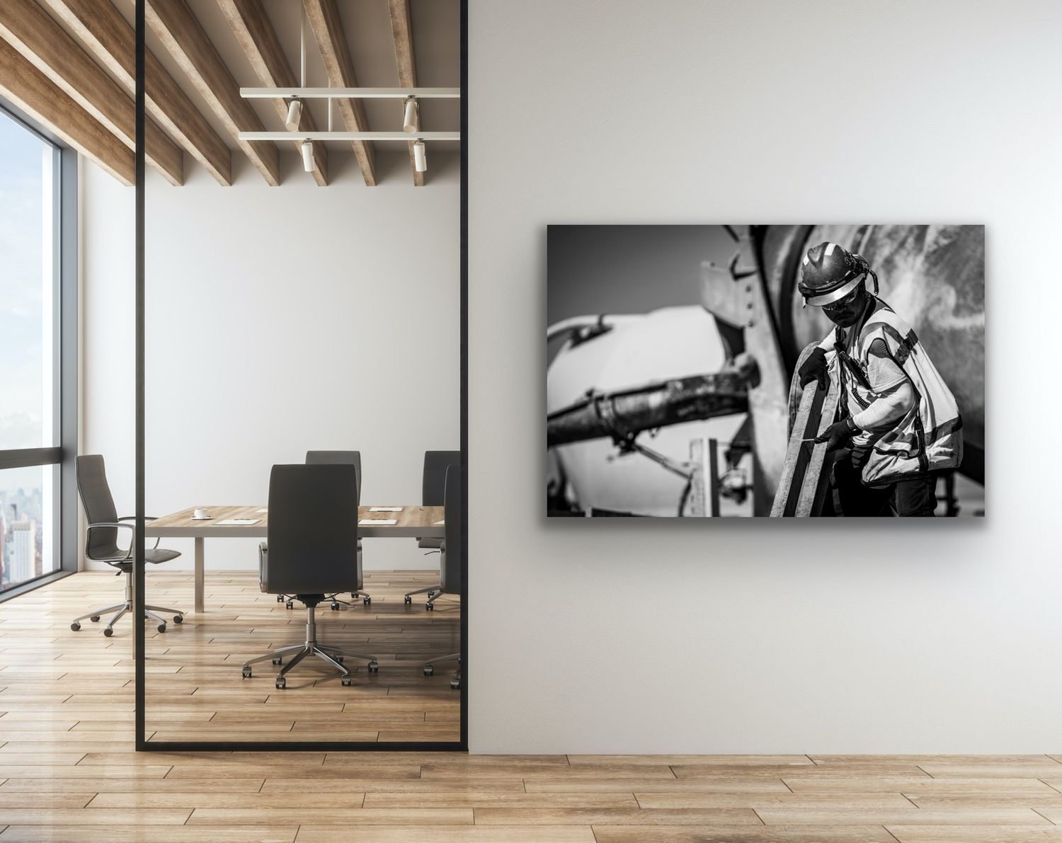 Modern office interior with wooden floors, large windows, and black and white aviation-themed artwork mounted on the wall.
