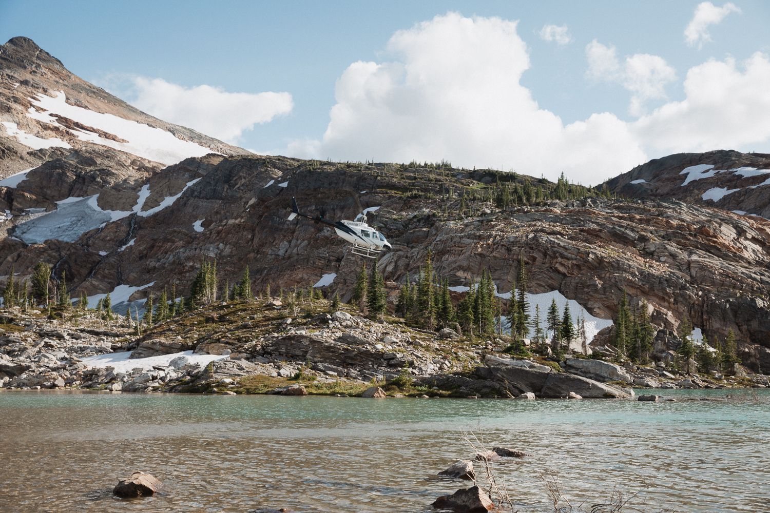 This was a fairytale elopement in Revelstoke, BC with Glacier Helicopters. The mountain top, skyline, and pastel wildflowers were a dream!