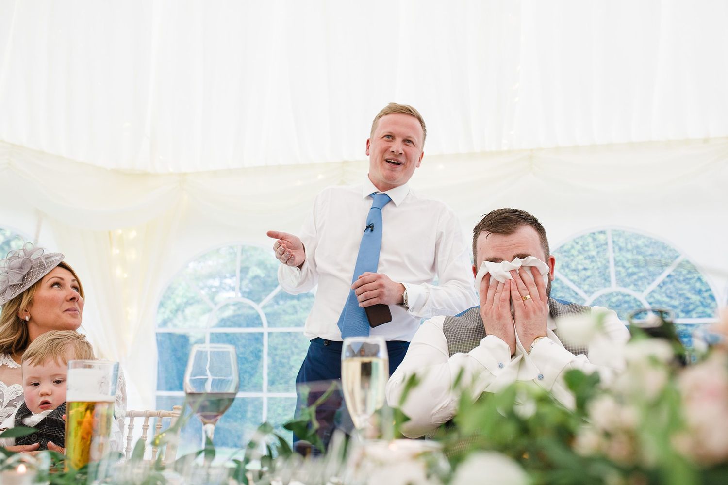 Wedding guests enjoying emotional speeches and candid moments during Fox Harb'r Resort wedding reception dinner.