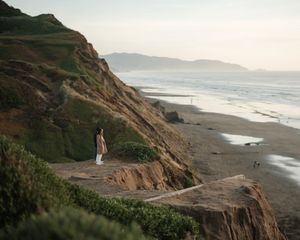Scenic coastal cliffside path overlooking dramatic ocean views at sunset.