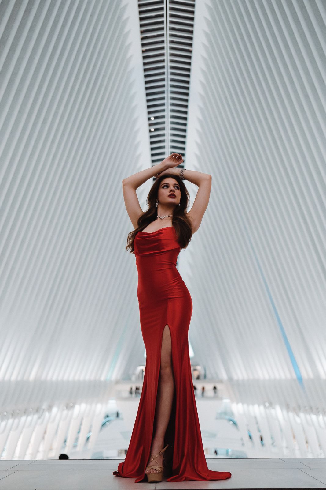 High-fashion Miami editorial of woman in bold red dress posing against sleek architecture. Pinterest-worthy portraits by MannyPortraits.