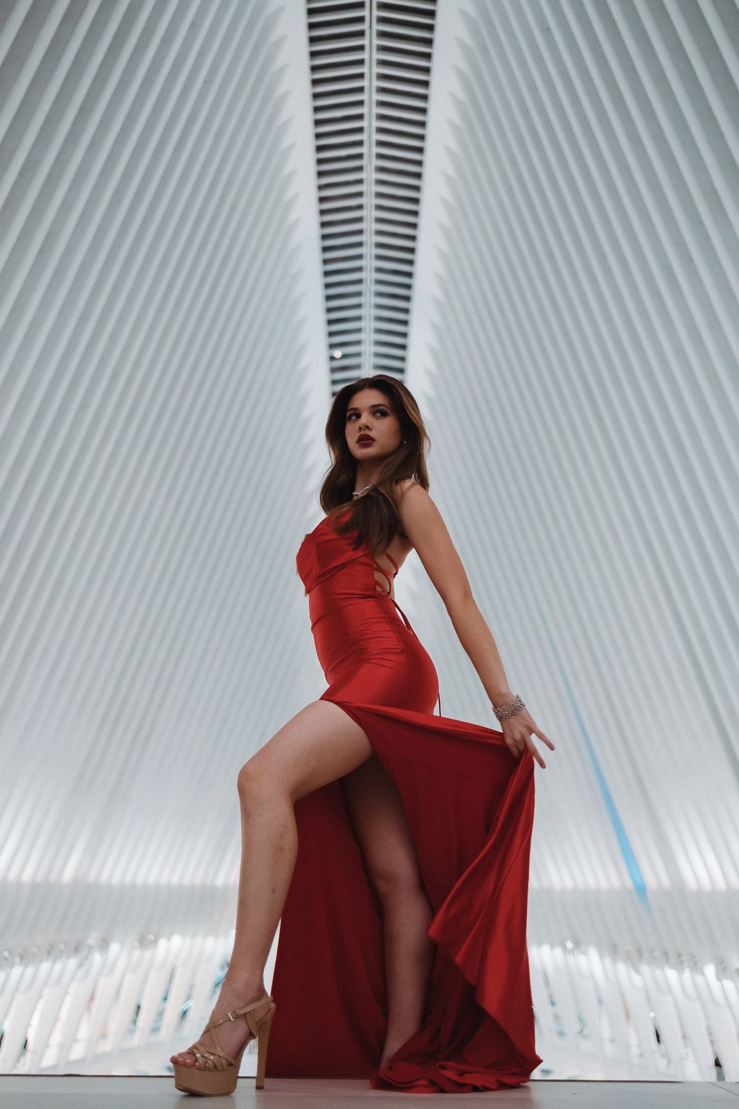 Elegant fashion editorial in Miami, model striking pose in red dress. Cinematic Instagram + Pinterest portrait by MannyPortraits.