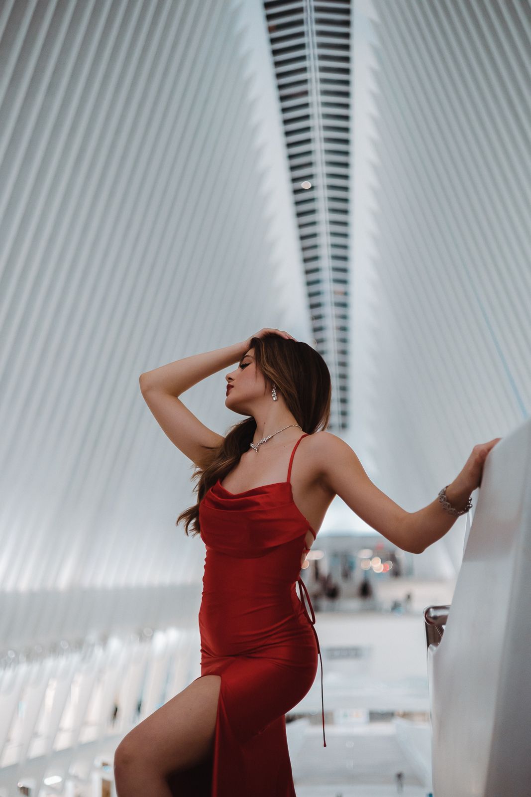 Cinematic portrait of woman in bold red dress framed by Miami architecture. Pinterest and Instagram fashion shoot by MannyPortraits.