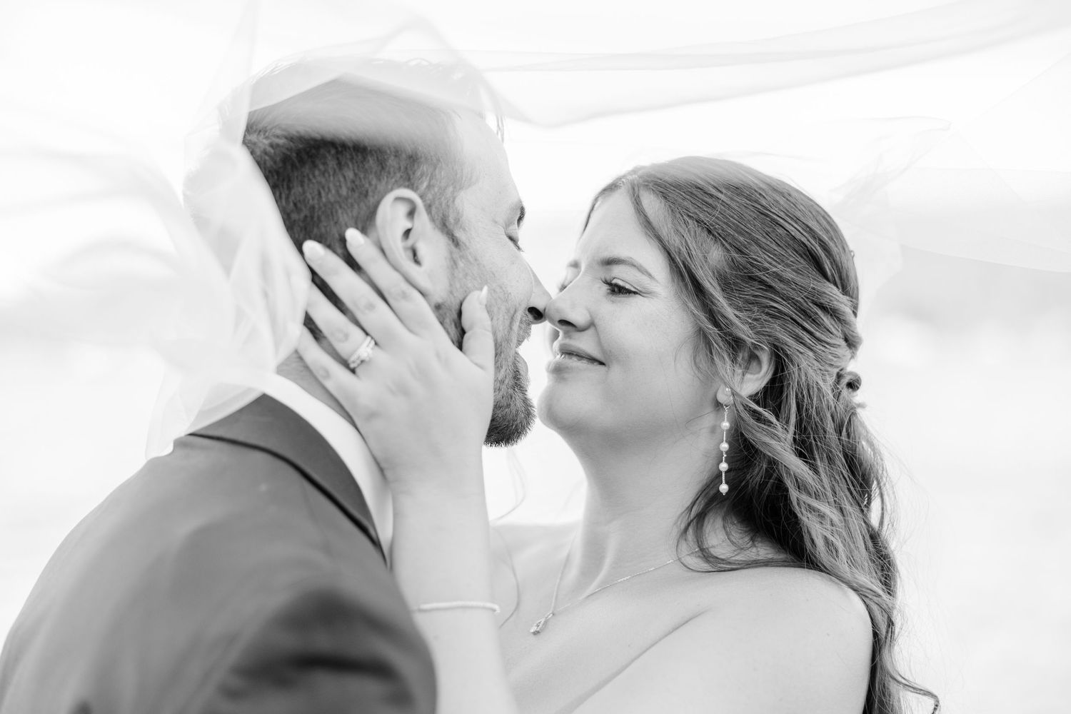 A romantic black and white wedding photograph series showing tender moments between a couple on their special day.