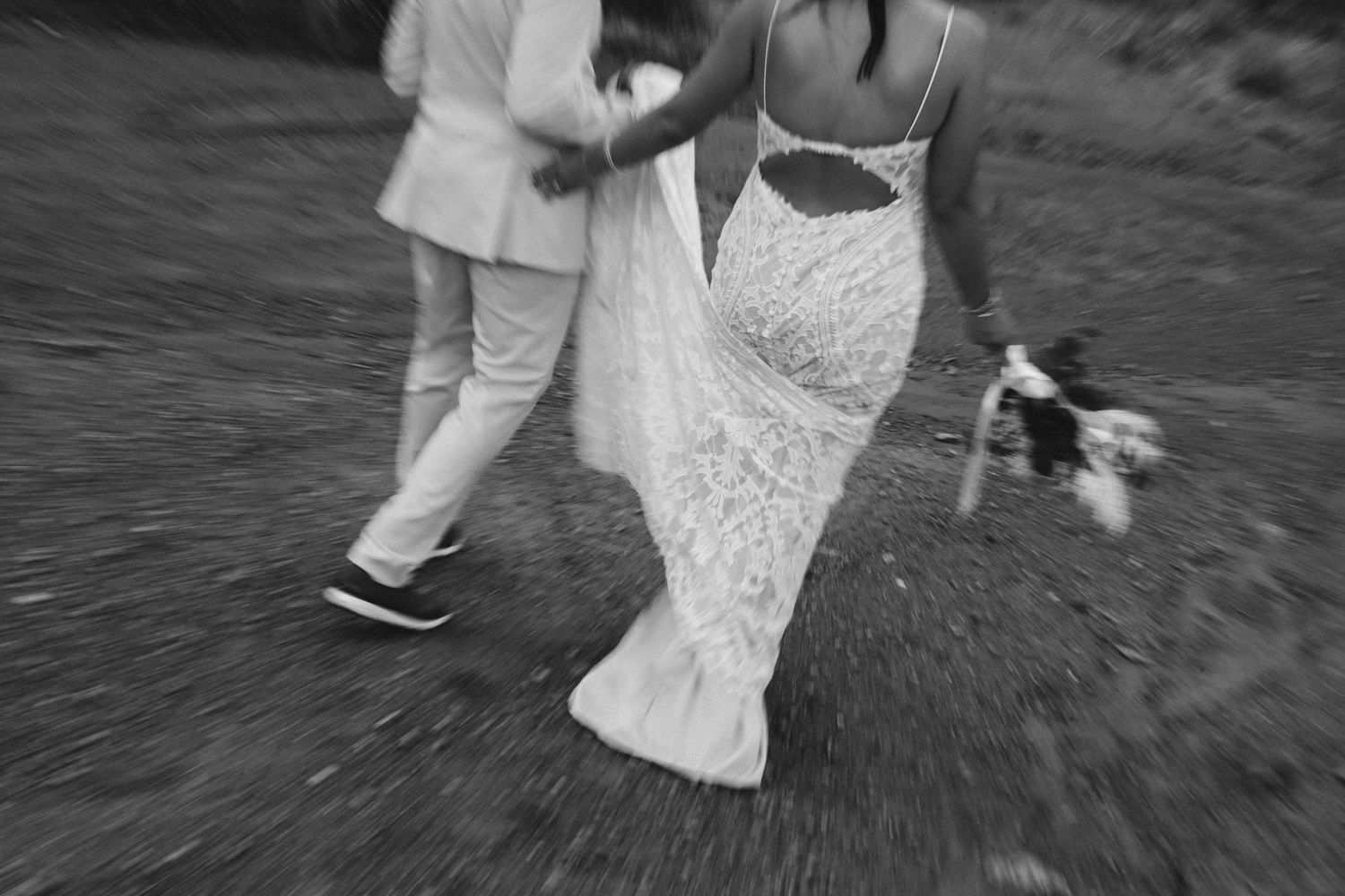 Black and white motion blur wedding photograph showing flowing dresses and movement.