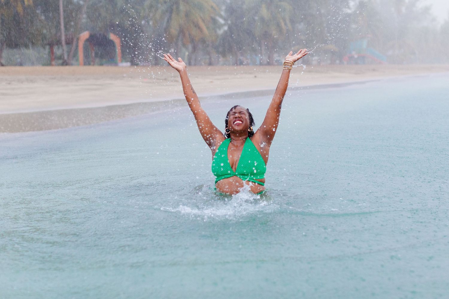 Portrait of a woman at the beach in the rain in Luquillo, Puerto Rico.