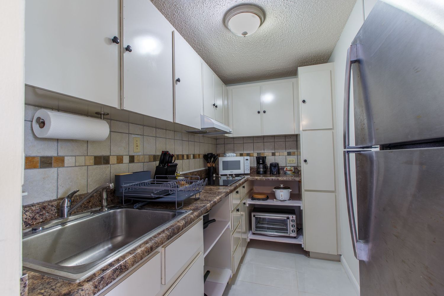 Real estate photography. Kitchen. Short-term rental in Playa Azul Tower 1 in Luquillo, Puerto Rico.