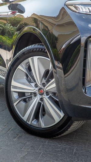 Detail shot of premium alloy wheels and tires on a luxury vehicle.
