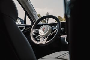 Black and white interior view of a premium vehicle dashboard with ambient lighting.