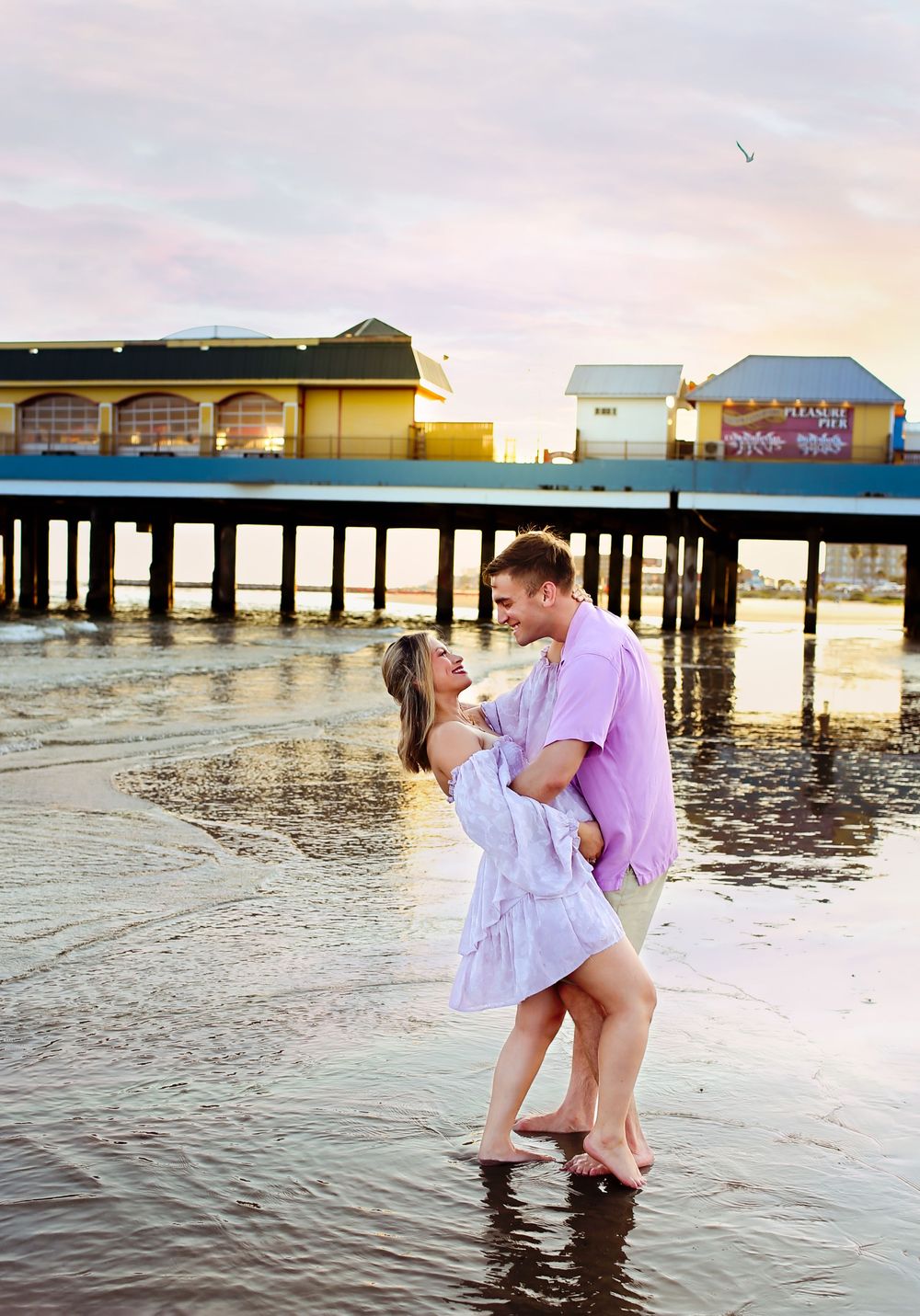 Mom and dad posing on beach for maternity session