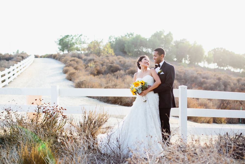Romantic sunset wedding photos with coastal backdrop and white gazebo.