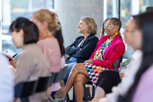 Business professionals sitting in a conference hall at a corporate event or seminar.
