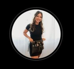 Casual portrait of a woman in black shirt and shorts against a white background on Maui, Hawaii.