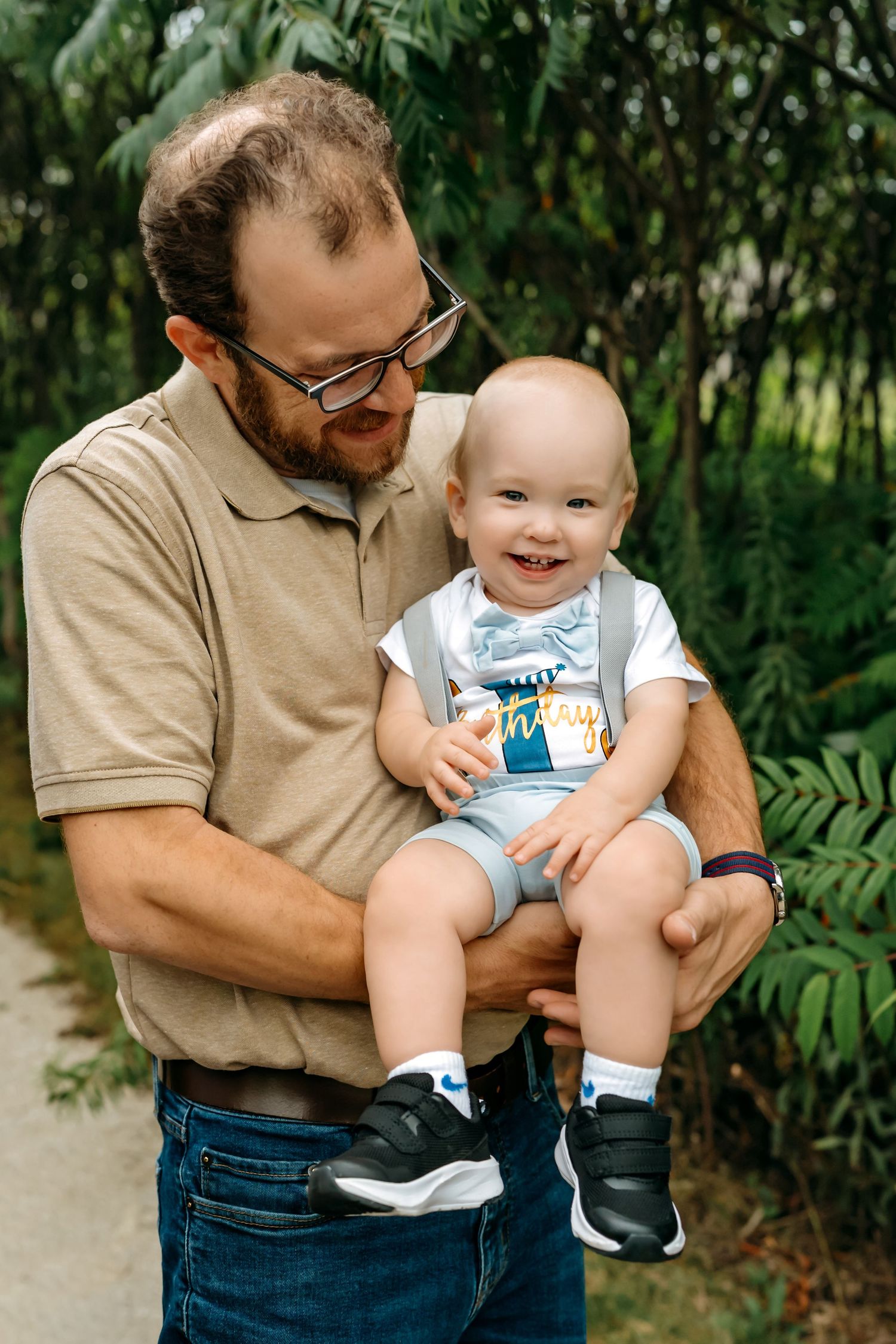 Sweet candid moment between parent and child playing together in a lush garden setting.