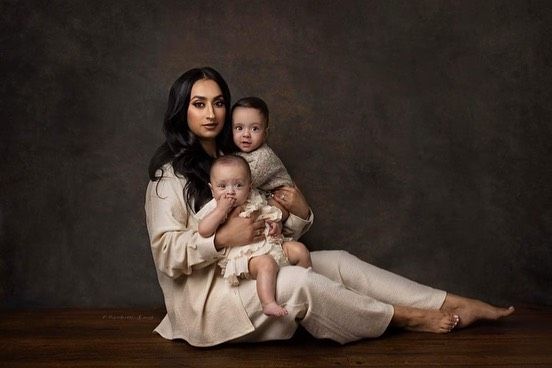 A series of artistic sepia-toned photographs showing intimate moments between a parent and baby in soft natural poses.