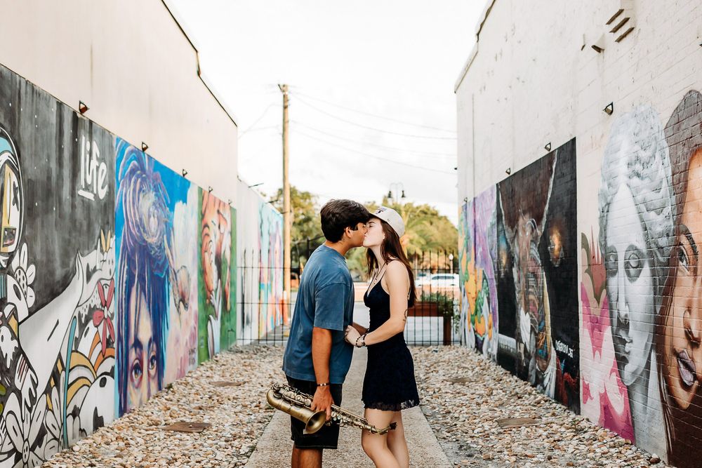 Six images of people exploring and interacting with colorful street art and graffiti-covered walls in an urban setting.