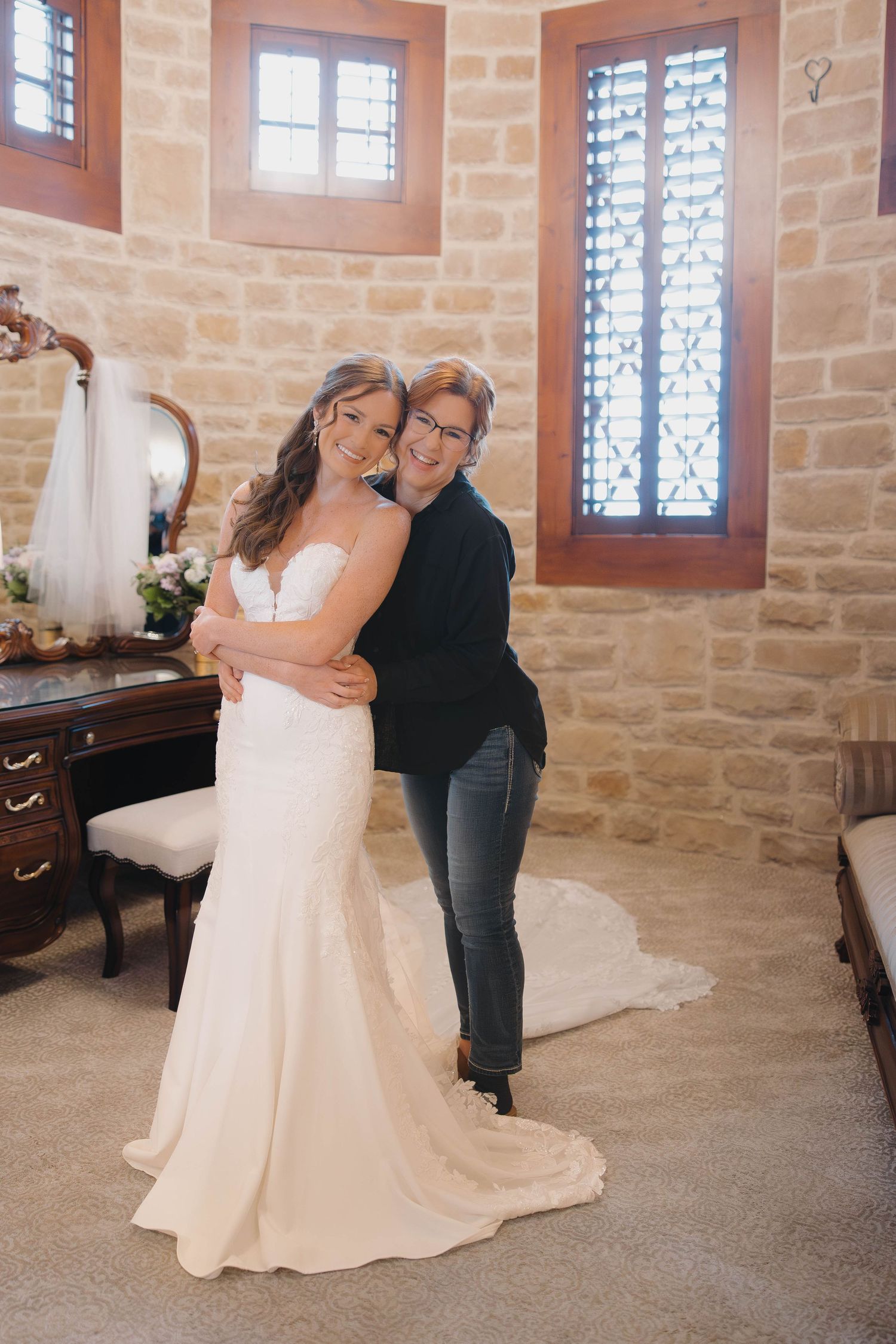 Beautiful bridal suite interior with stone walls, windows and natural lighting.