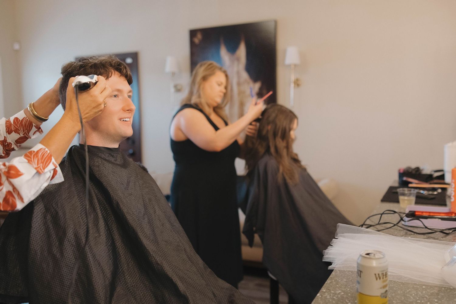 Behind the scenes shots show wedding day preparations in progress.