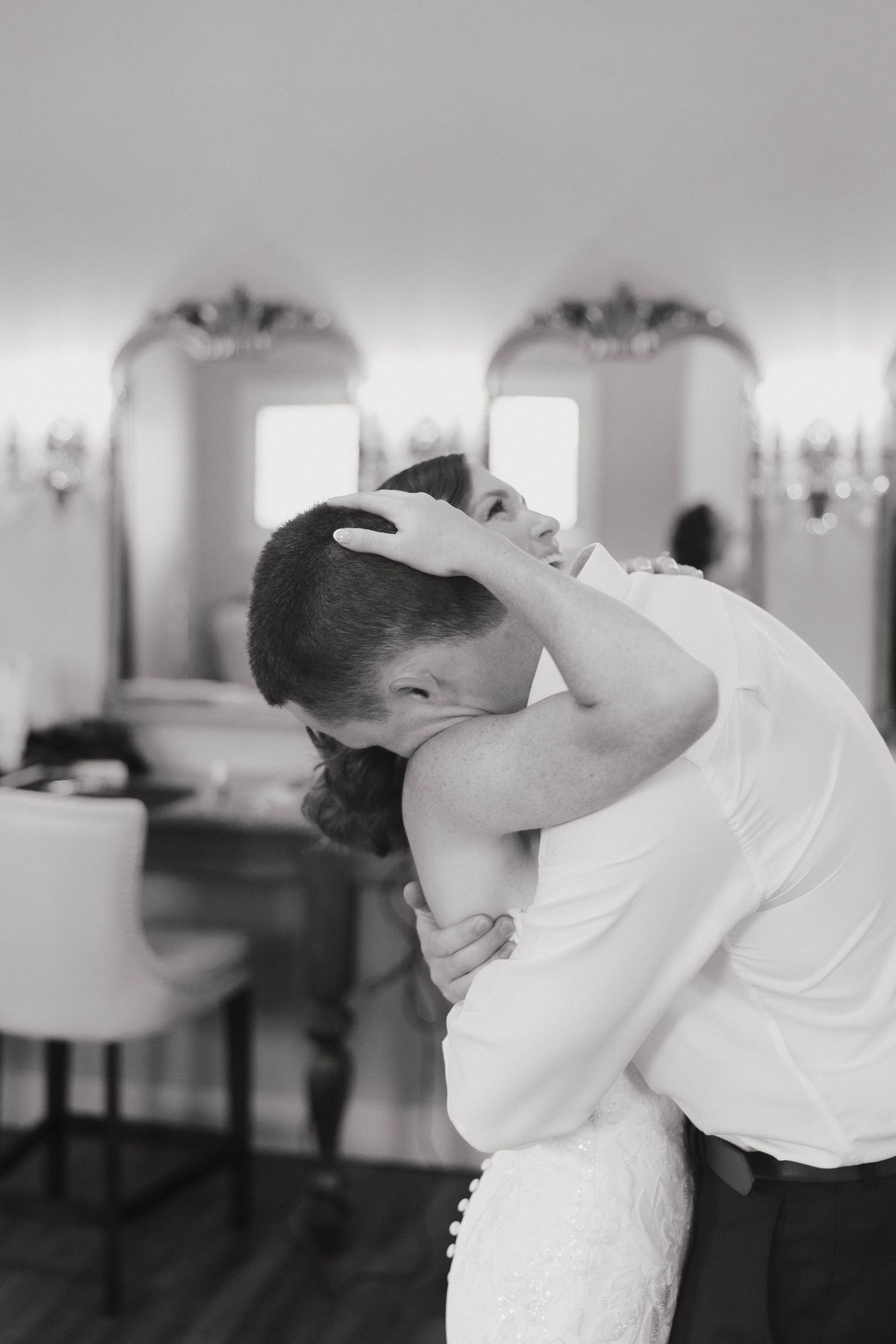 A romantic black and white scene captures an intimate wedding dance dip sequence across multiple frames.