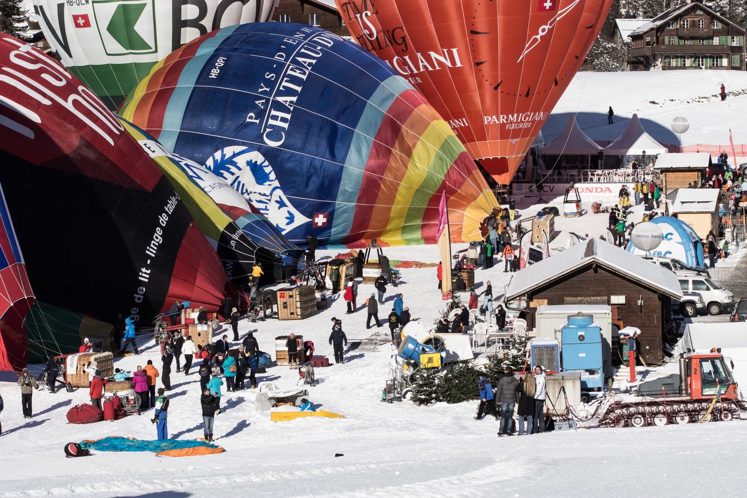 Panoramic sequence of a snowboarder performing aerial tricks off a large snow jump at a winter terrain park.