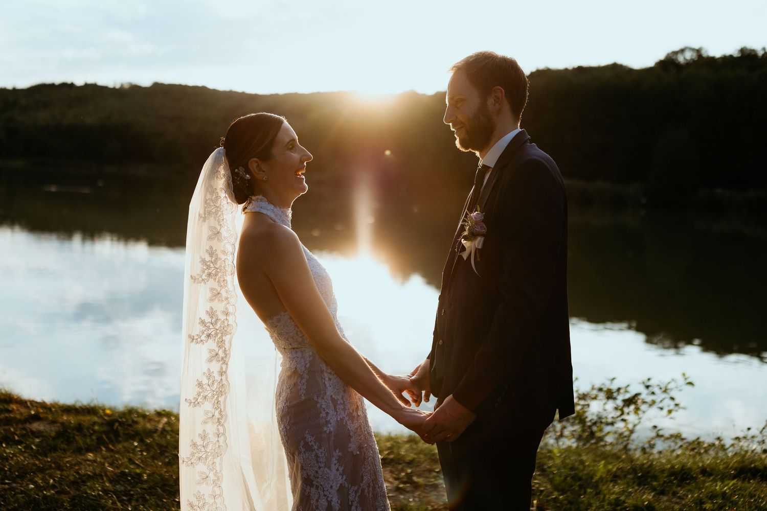 Close-up of two people holding hands tenderly near a window with soft natural light.