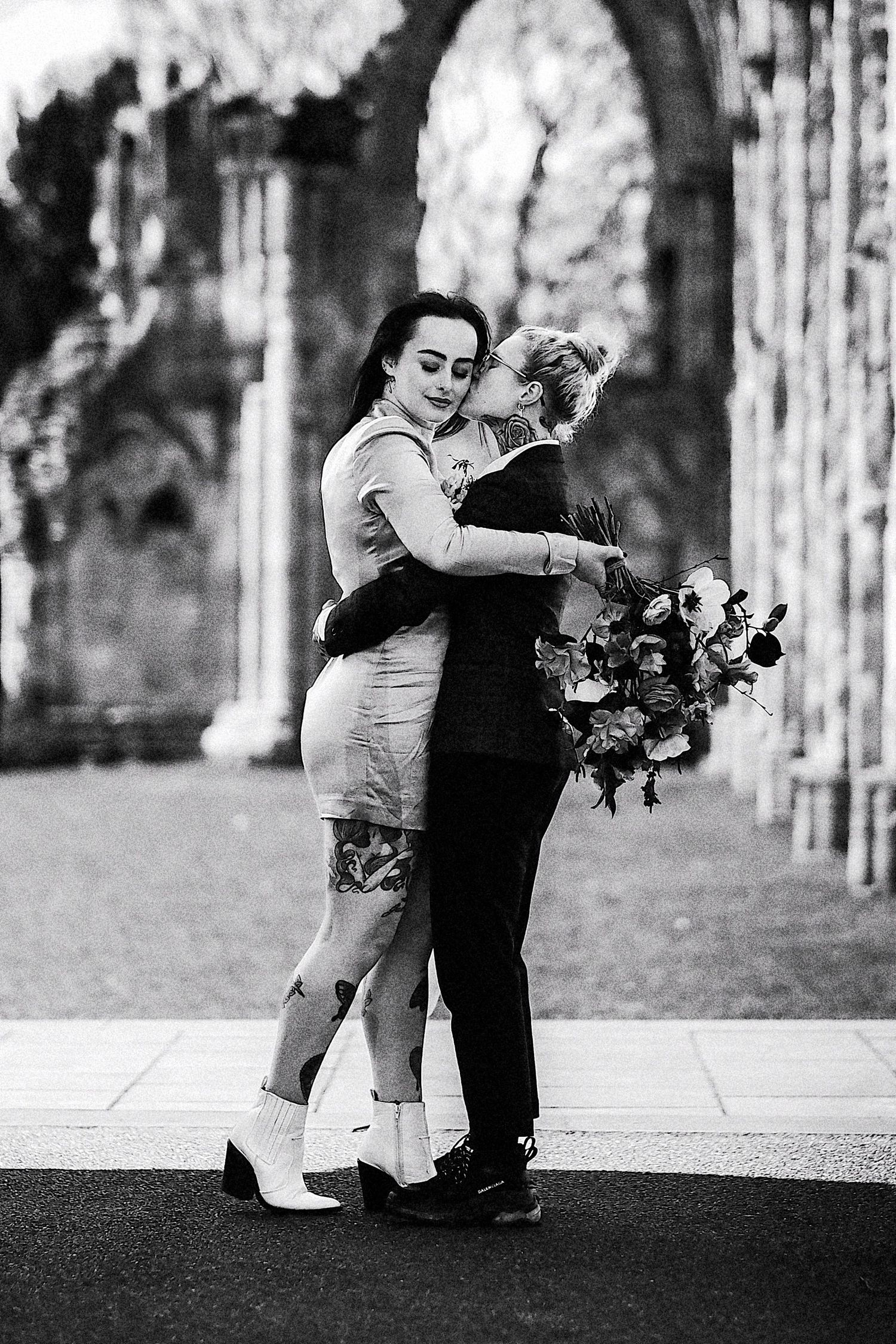 A romantic black and white photo sequence shows a couple dancing together outdoors among trees.