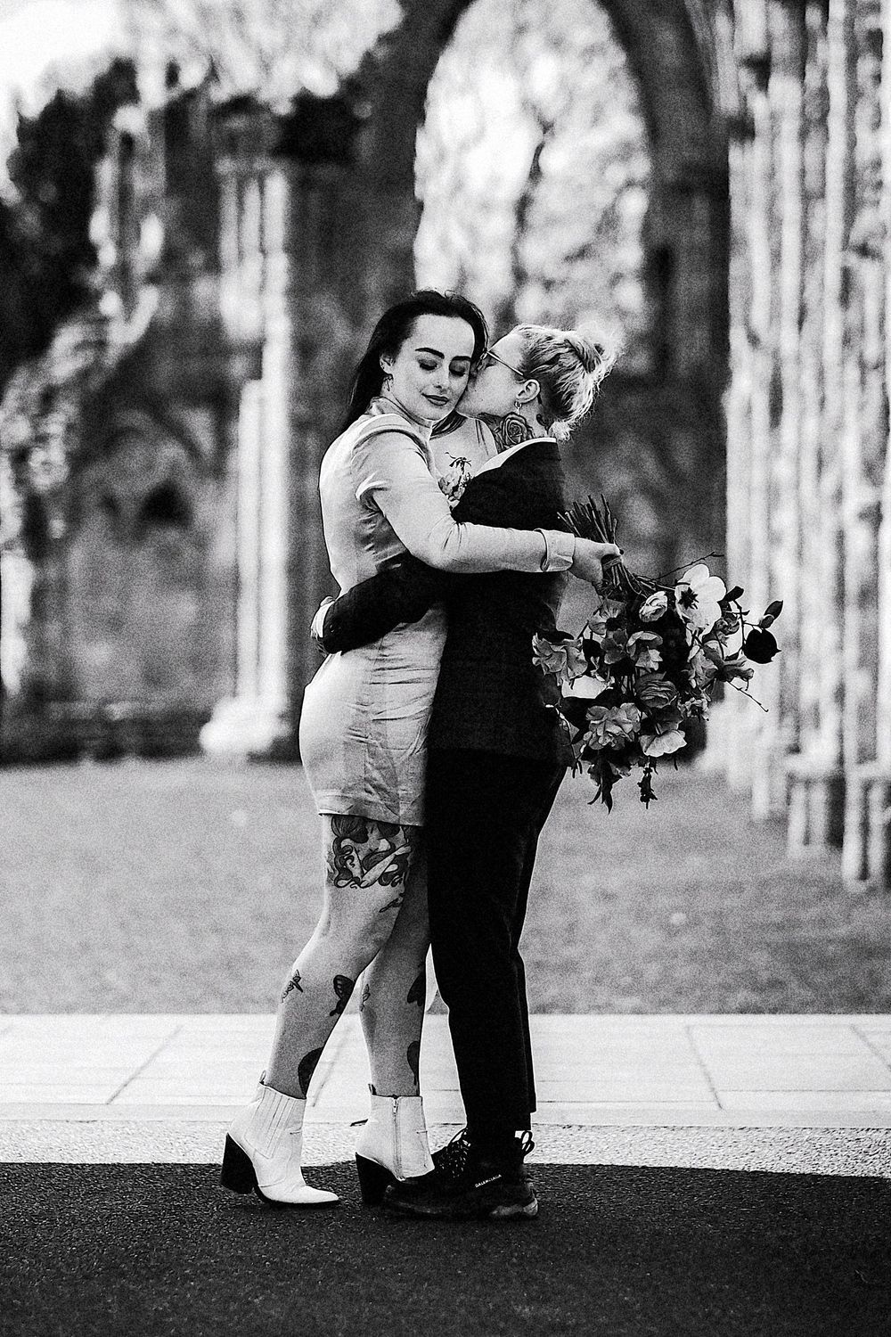 A romantic black and white photo sequence shows a couple dancing together outdoors among trees.